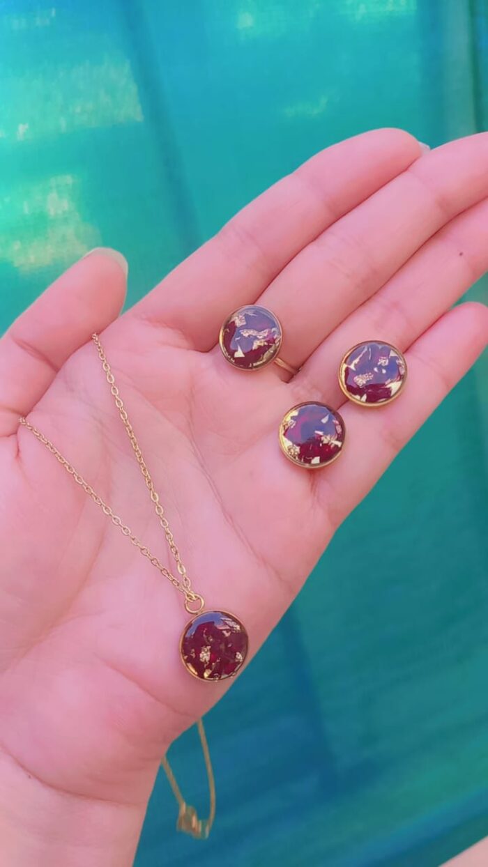 Handcrafted resin jewelry set featuring 12mm gold foil studs, matching pendant with chain, and adjustable ring.