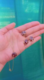 Handcrafted resin jewelry set featuring 12mm gold foil studs, matching pendant with chain, and adjustable ring.