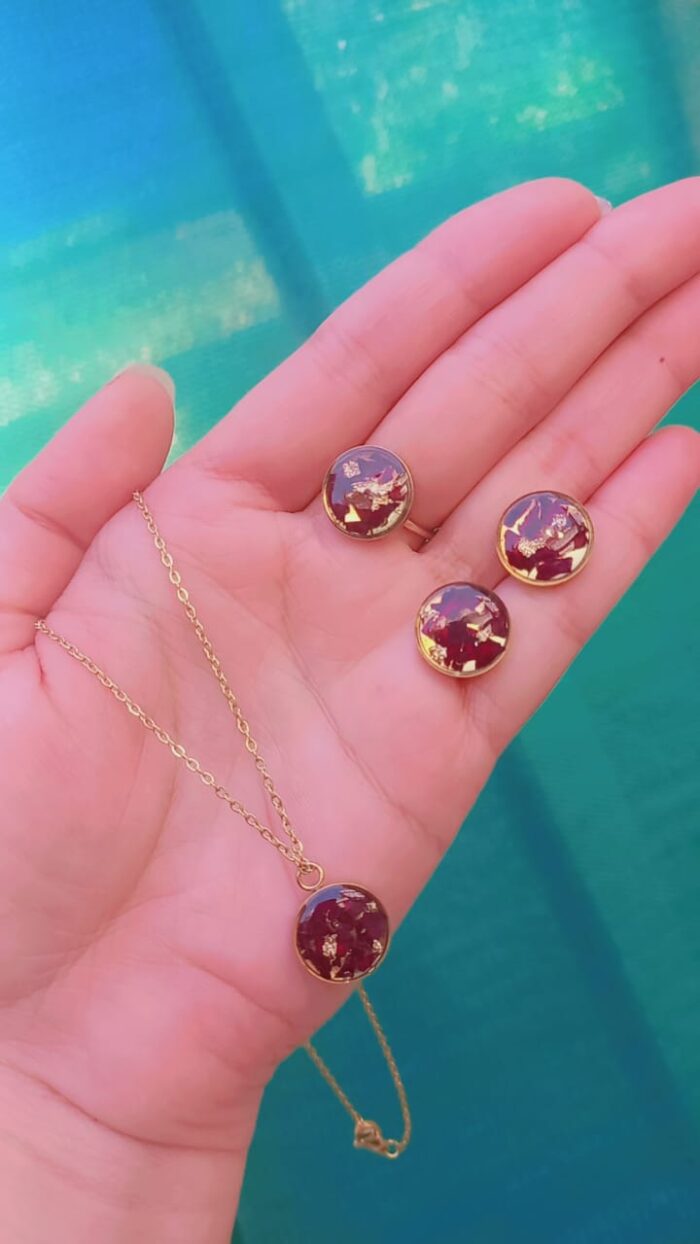 Handcrafted resin jewelry set featuring 12mm gold foil studs, matching pendant with chain, and adjustable ring.