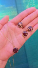 Handcrafted resin jewelry set featuring 12mm gold foil studs, matching pendant with chain, and adjustable ring.